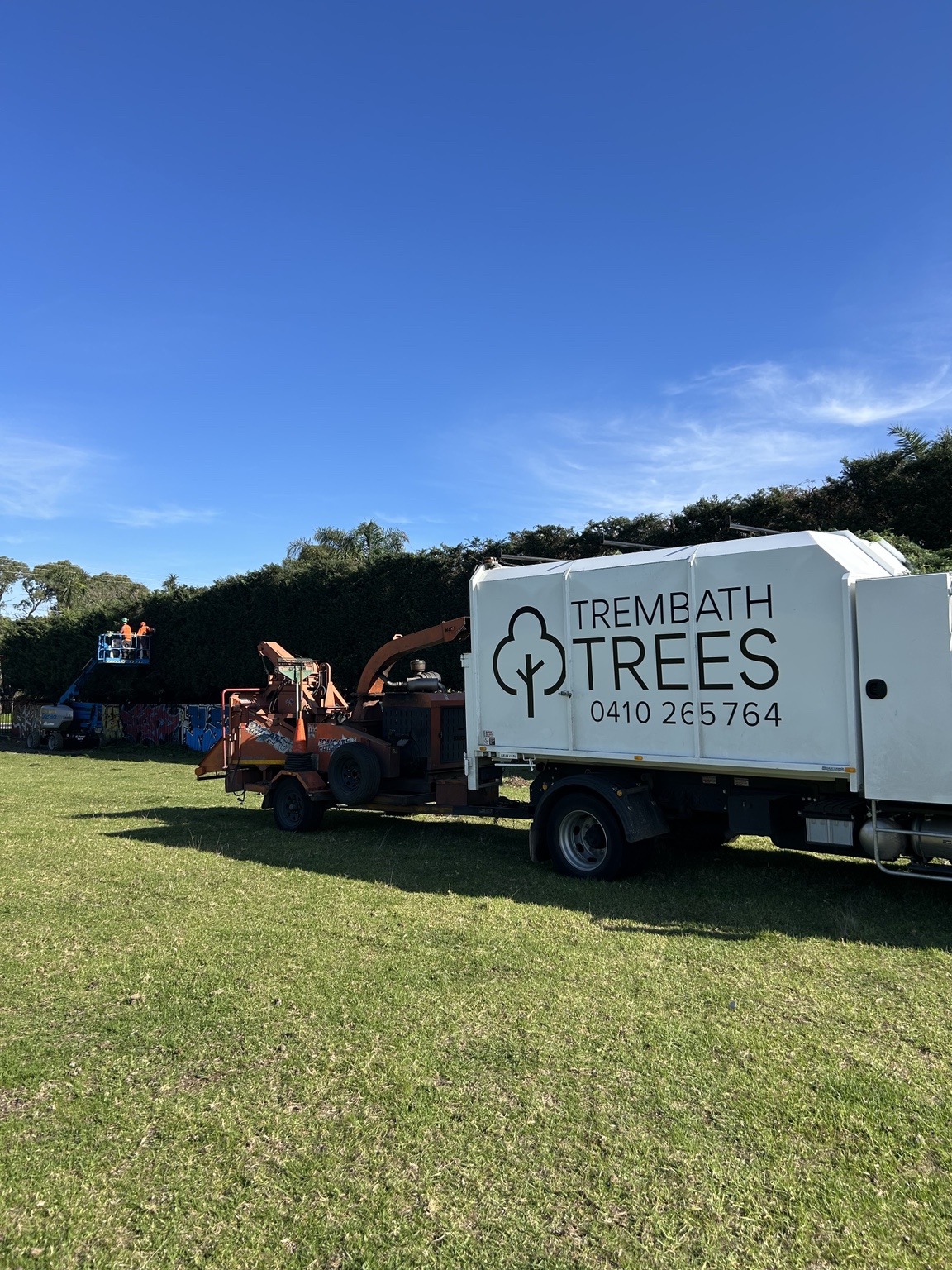 Trembath Trees truck and wood chipper on site